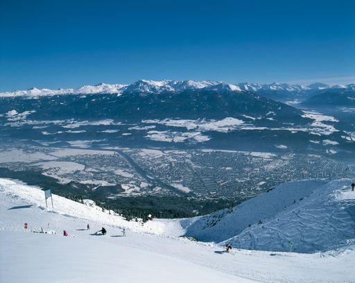 Wahrhaft olympisch: Mit Blick auf die Stadt Innsbruck ziehen Skifahrer und Snowboarder im Skigebiet Nordpark ihre Schwünge.