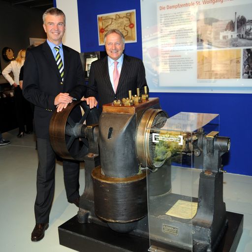 Der erste Generator, der 1892 in St. Wolfgang erstmals in Oberösterreich Strom in ein öffentliches Stromnetz eingespeist hat, ist in der Ausstellung der Energie AG, den "Stromgeschichten" zu sehen. Generaldirektor Leo Windtner (r.) und Technik-Vorstand Werner Steinecker sind stolz auf das beispielgebende Projekt am historischen Kraftwerksstandort in Timelkam.