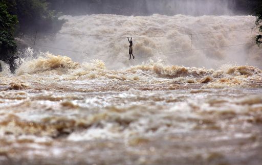 Vorschau Bild von Mekong River, Laos. Fisherman Samniang risks his life on his homemade high wire stretched across the flooded Mekong.