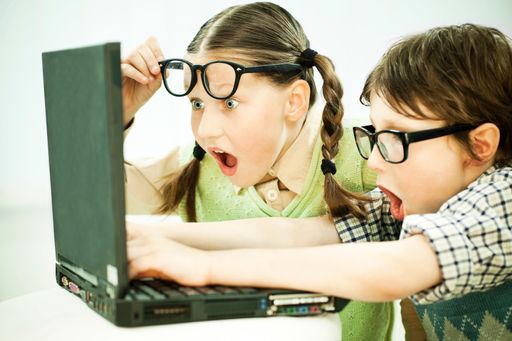 Vorschau Bild von Two children nerds looking at the laptop with open mouths