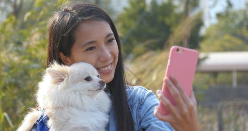  Woman taking selfie with her dog
