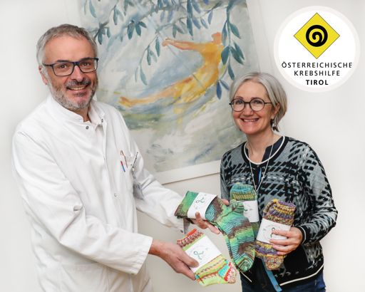 Vorschau Bild von Krebshilfe-Tirol-Präsident und Leiter des
zertifizierten gynäkologischen Zentrums, Med.Uni.Innsbruck,
Univ.-Prof. Dr. Christian Marth und Krebshilfe-Tirol-GF Anita Singer
bei der Übergabe der ersten Lieferung von grünen Socken.