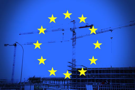  European flag with building construction as a background.