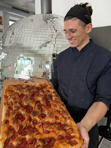 Chef-Pizzabäcker Davide Presciutti mit einer Focaccia mit Tomate